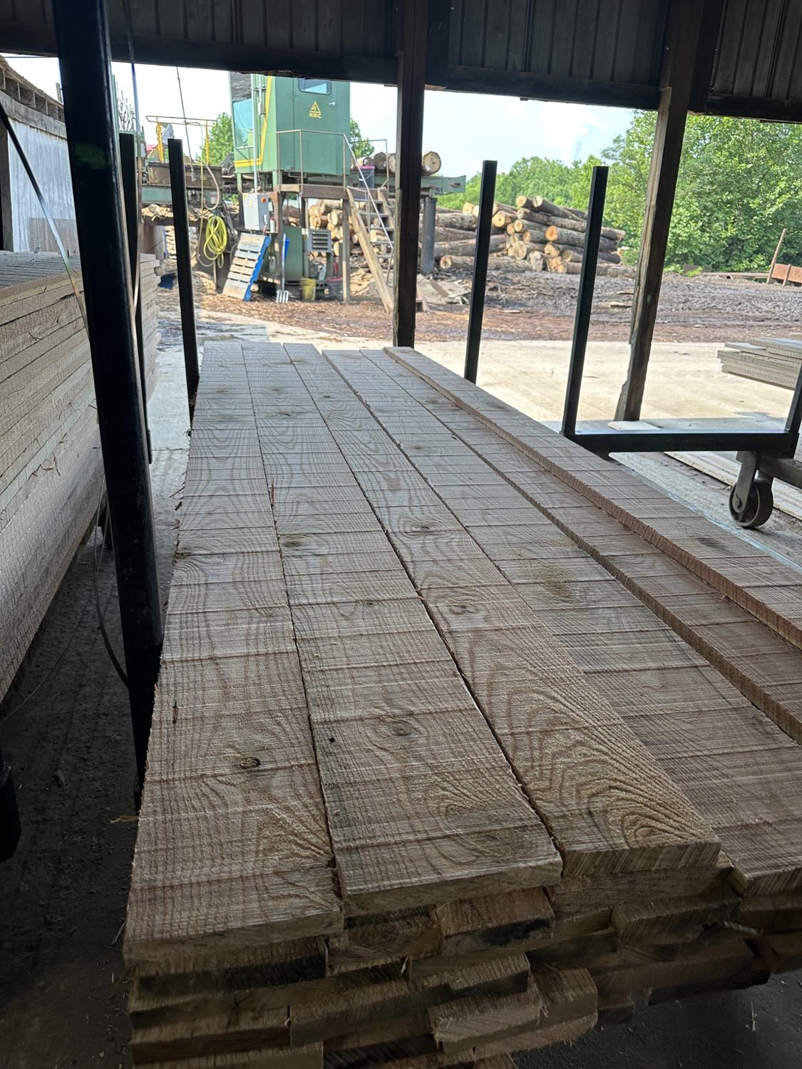 Freshly sawn rough-cut boards stacked at the mill